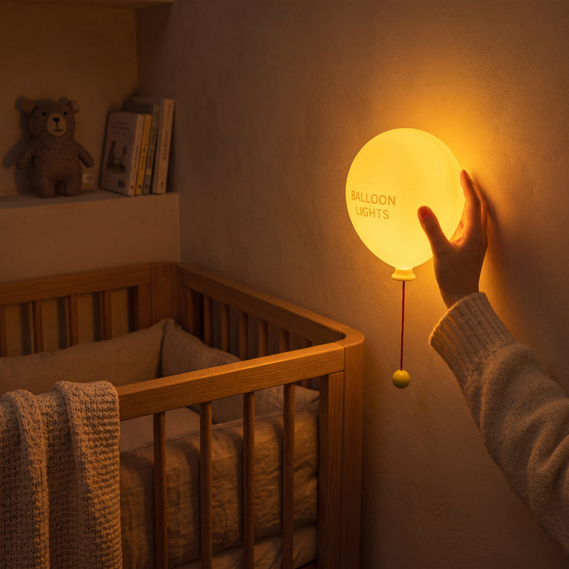 Warm glow balloon lamp mounted above a kids nursery crib.